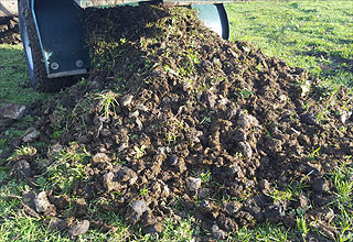 Super Groomer emptying collected horse manure